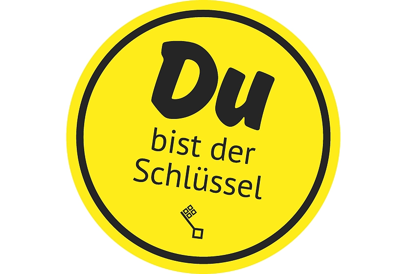 Gelbe, runde Button-Grafik mit der Aufschrift Du bist der Schlüssel